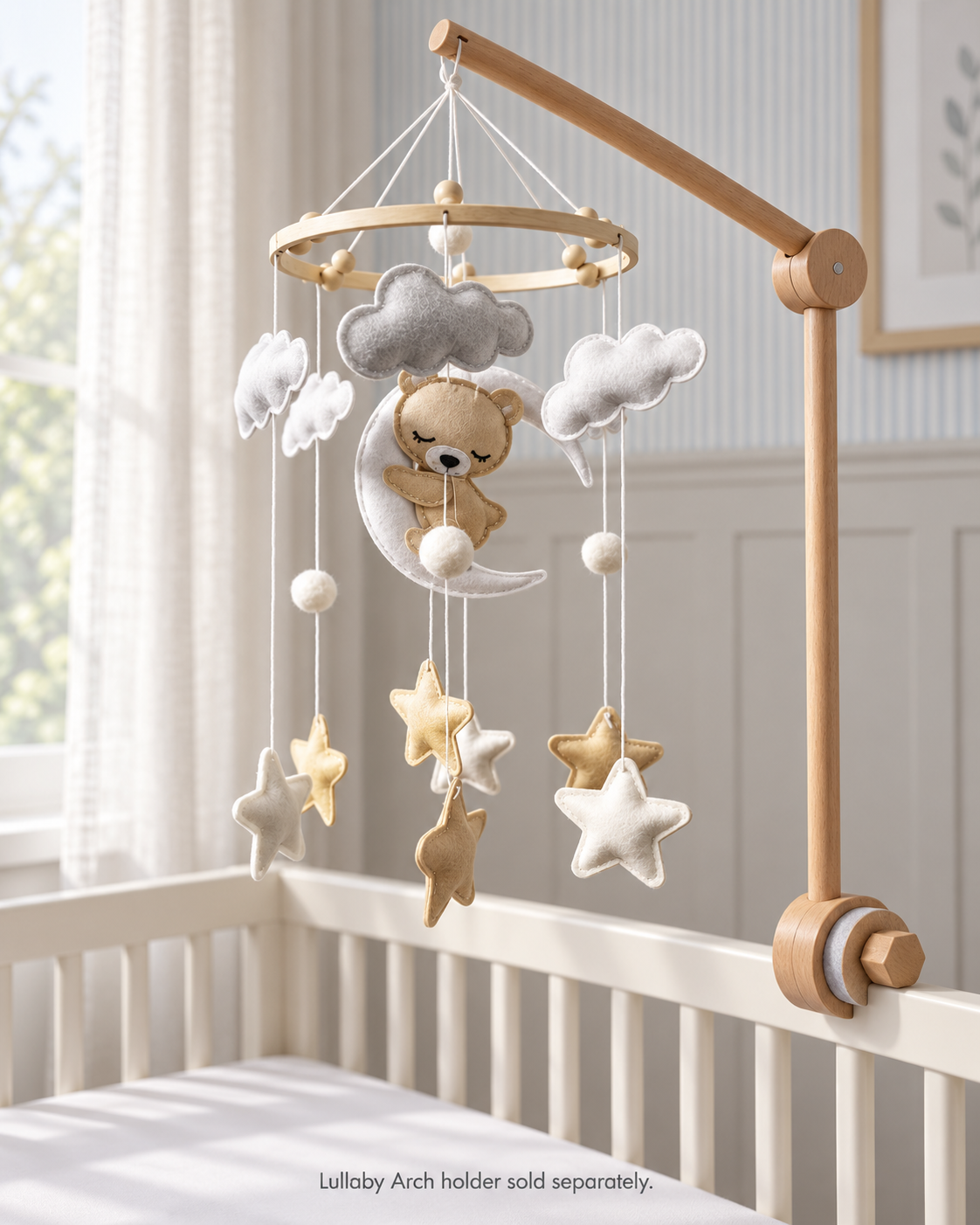 Bear on the Moon felt mobile in a softly lit nursery, shown with a Lullaby Arch holder sold separately