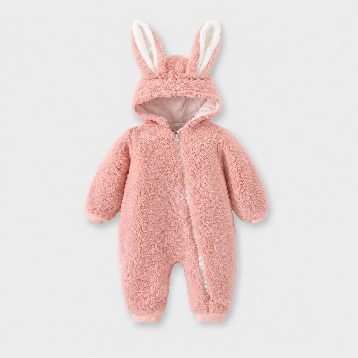 Cozy Bunny pink fleece romper with long bunny ears and diagonal zip on a light grey studio background