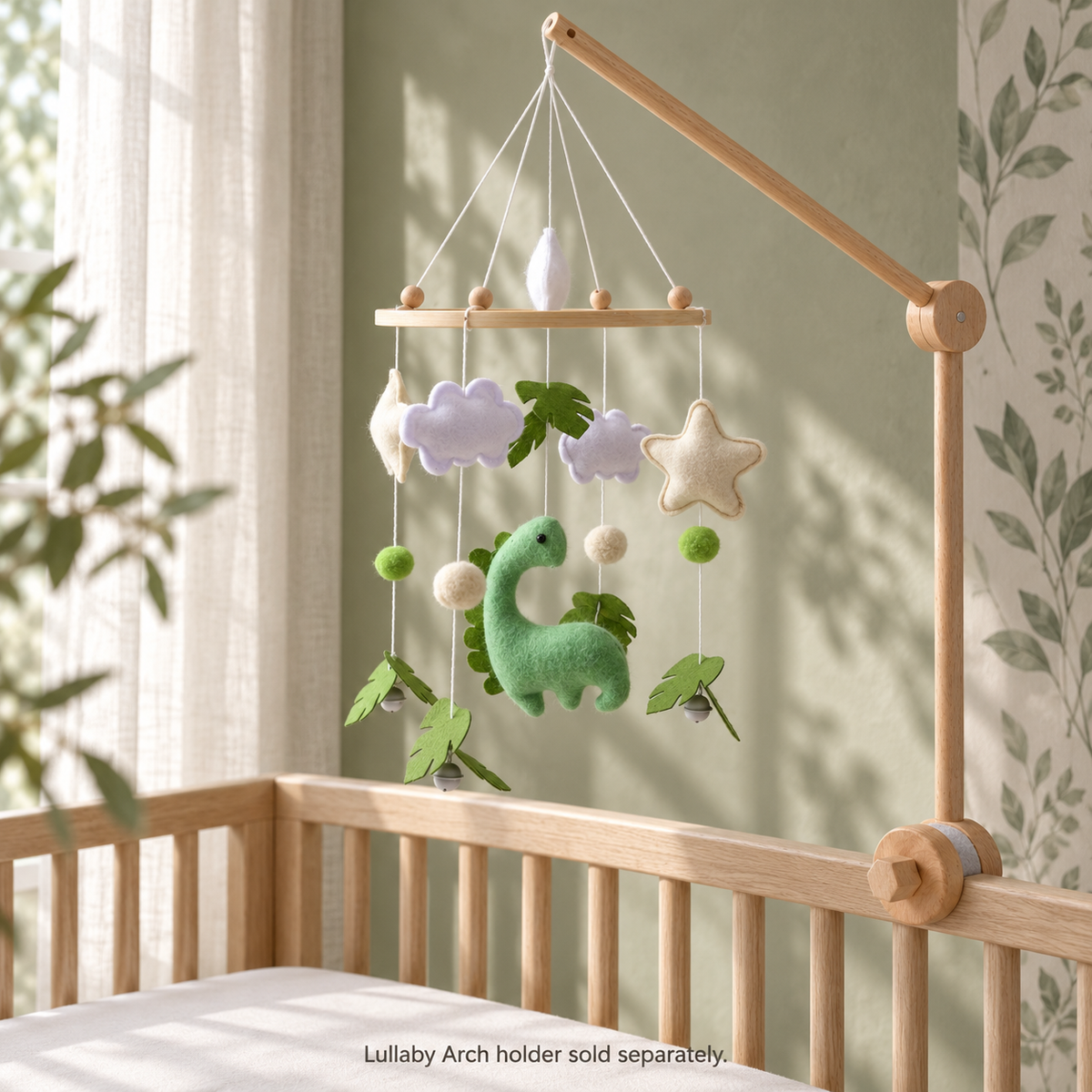 Dino Forest mobile in a sage nursery on the separately sold Lullaby Arch Aura 360 Loom holder