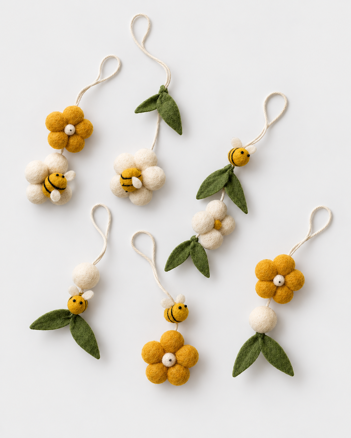 PerfectBaby Dream Arch felt bee and flower hanging toys arranged on a light grey background