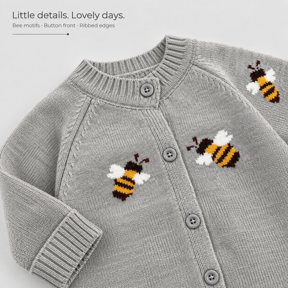 Grey Bee Knit Romper — bee motifs, grey button front and ribbed neckline and cuffs.