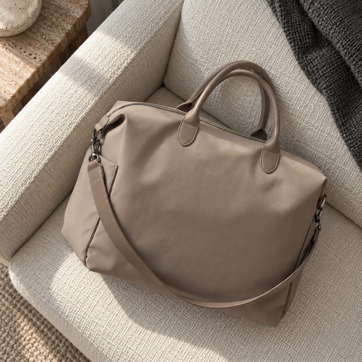 Beige Oxford Mother Bag resting diagonally on an ivory sofa in natural window light