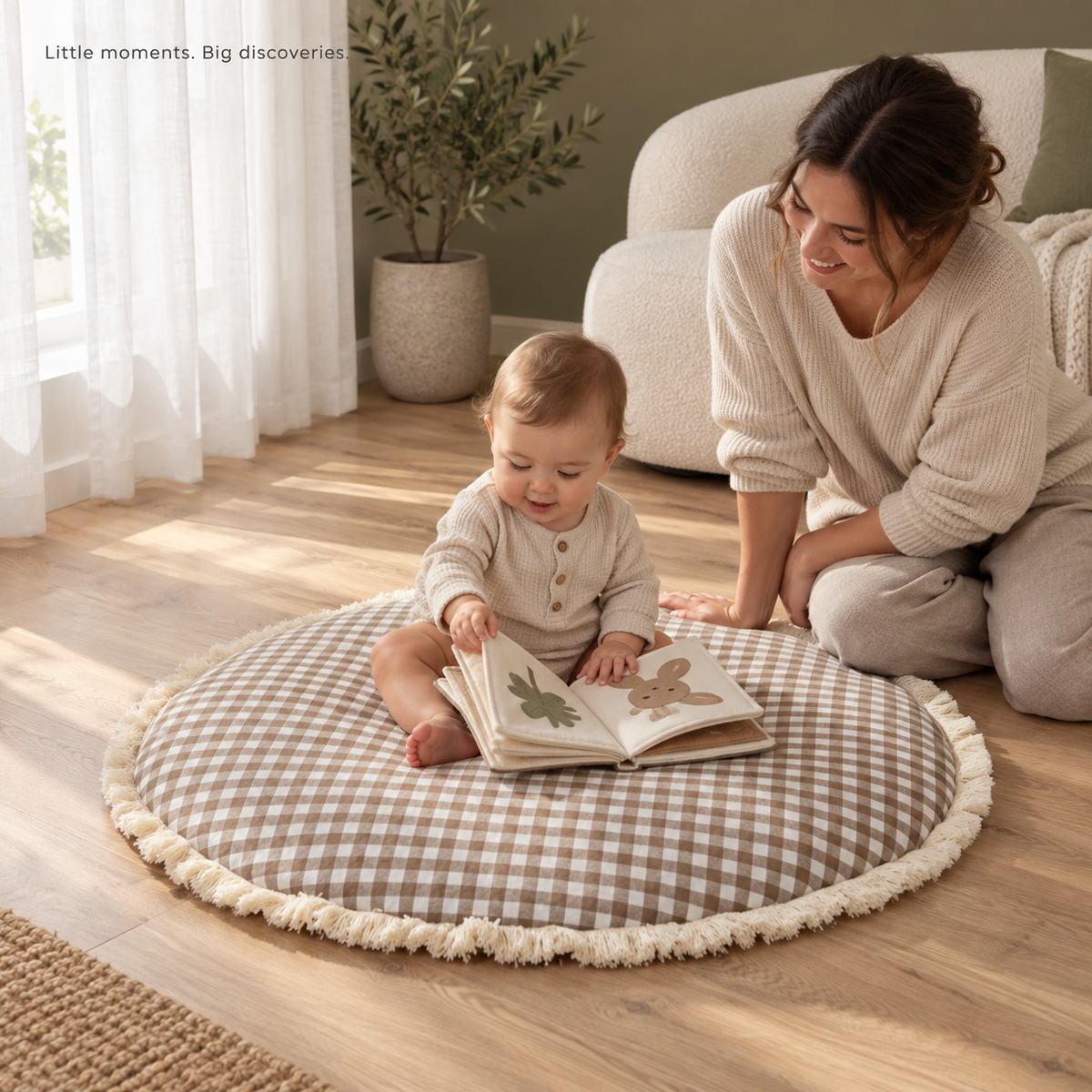 Brown gingham fringed play mat with an awake baby reading beside a parent