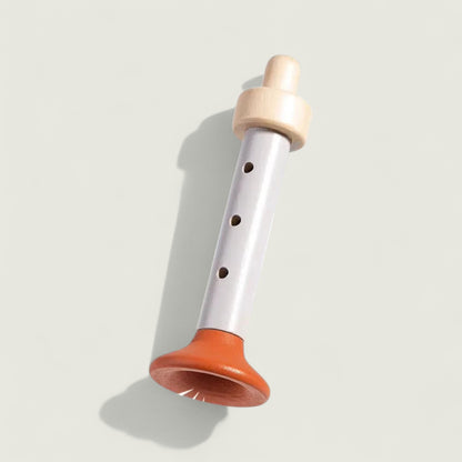 Wooden recorder with orange base on a light gray background