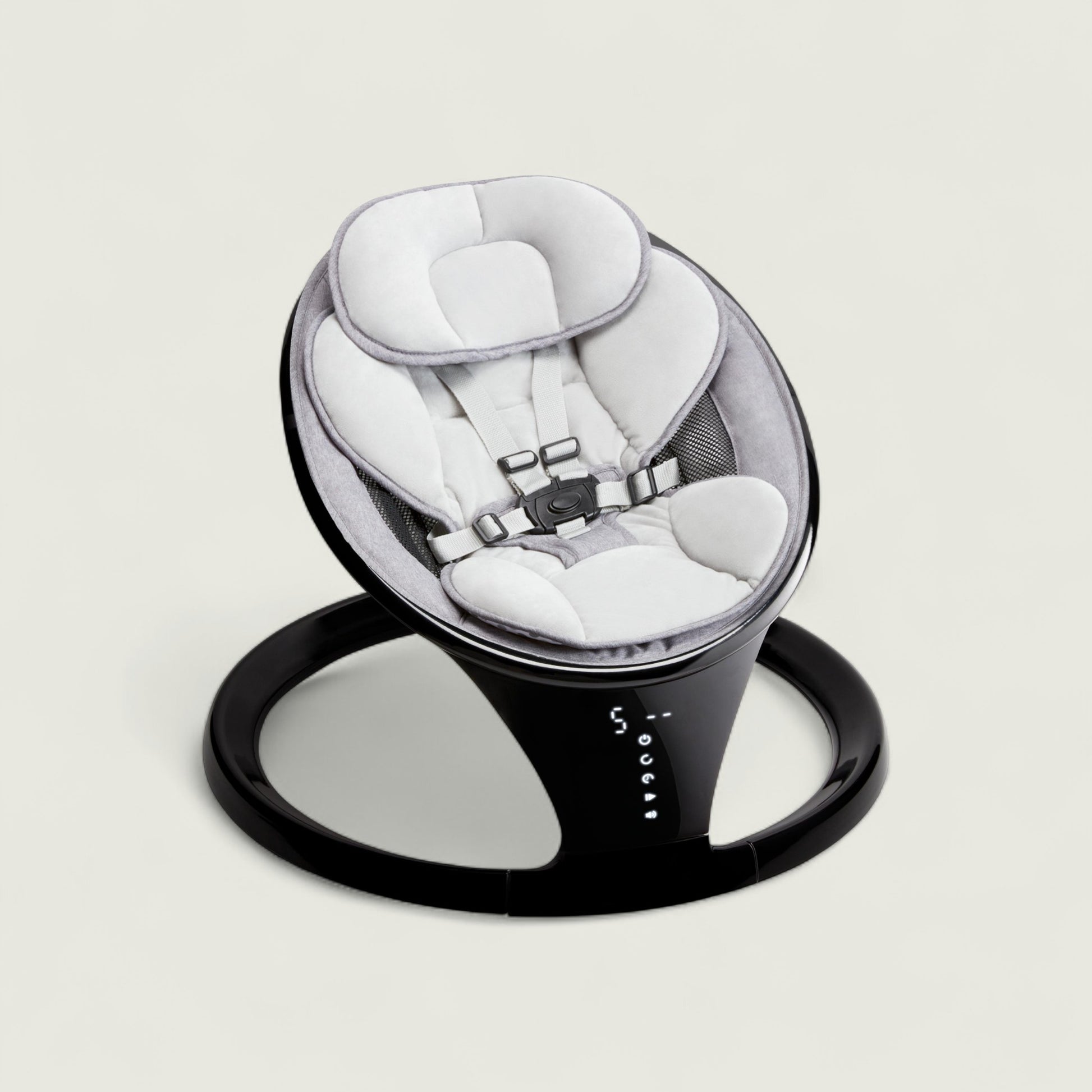 Baby swing with white seat and black base on a light gray background
