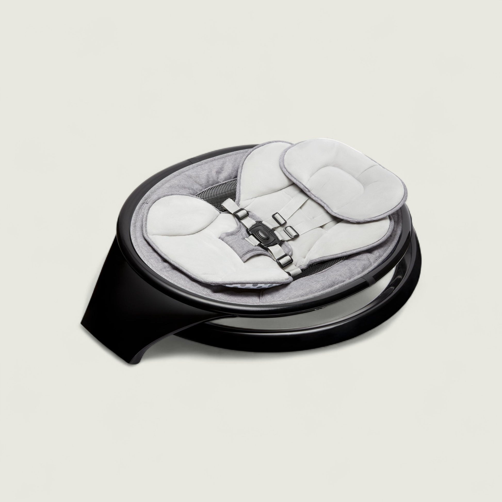 Baby seat with black base on a light gray background
