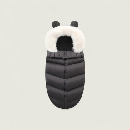 Black puffer baby bag with white fur hood on a light gray background