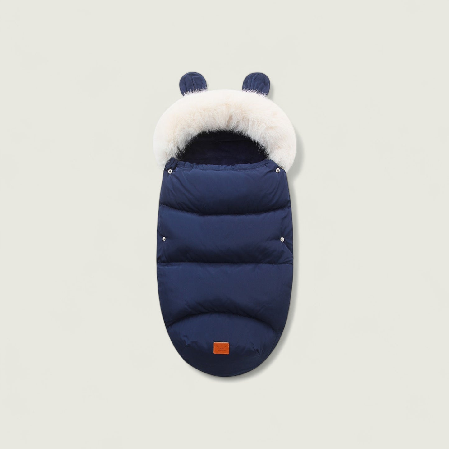 Navy blue baby sleeping bag with white fur hood on a light gray background