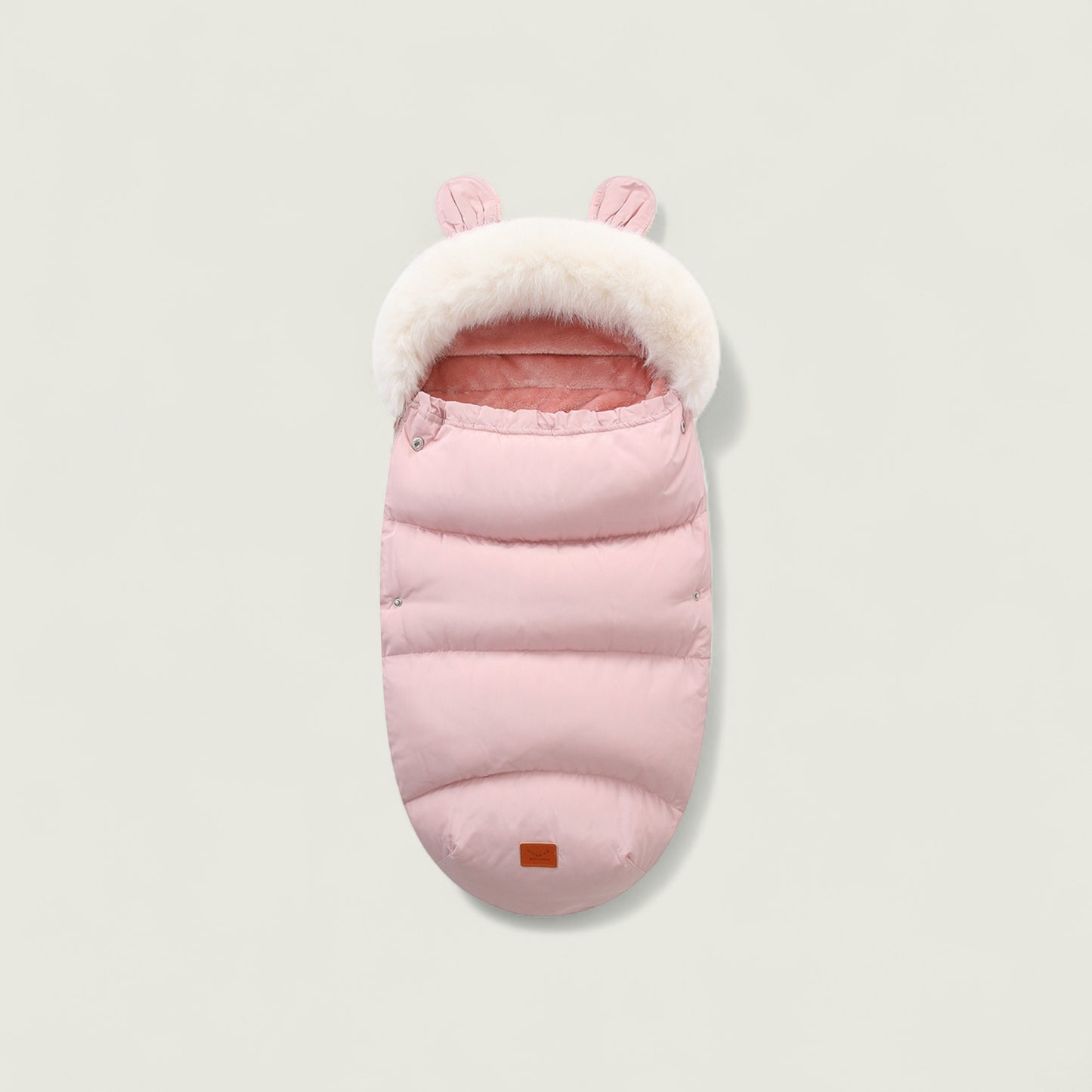Pink baby sleeping bag with white fur trim on a light gray background