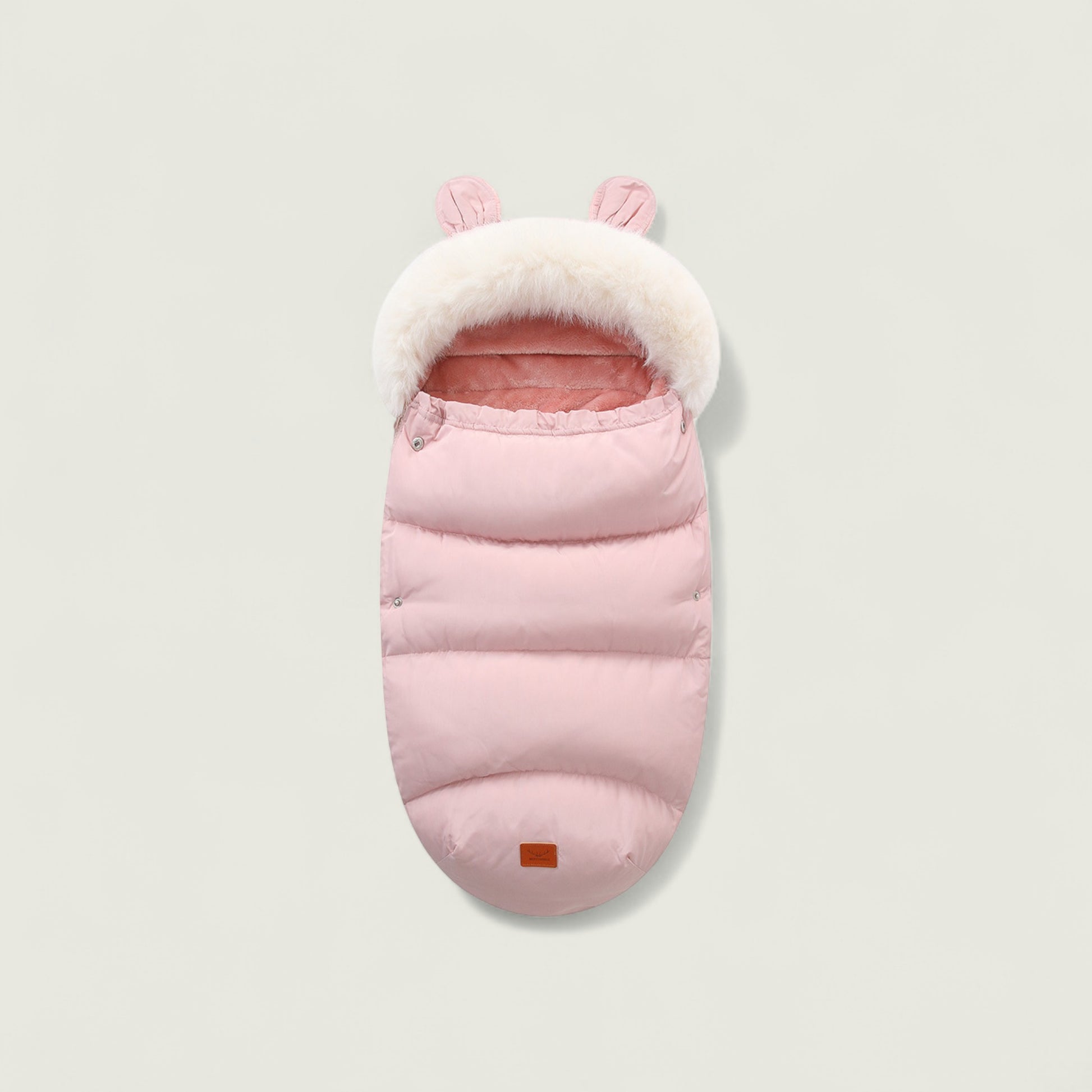 Pink baby sleeping bag with white fur trim on a light gray background