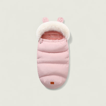 Pink baby sleeping bag with white fur trim on a light gray background