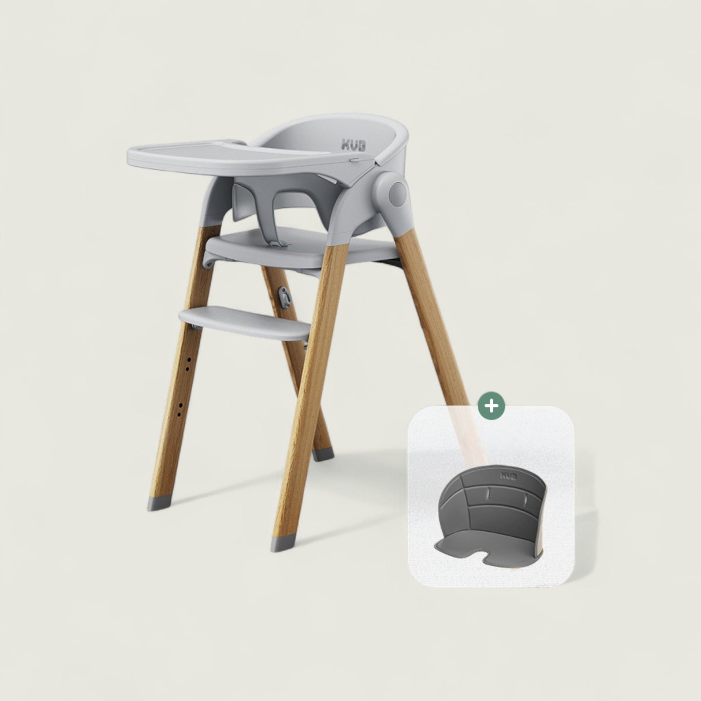 Children's high chair with wooden legs and gray seat and tray on a light background
