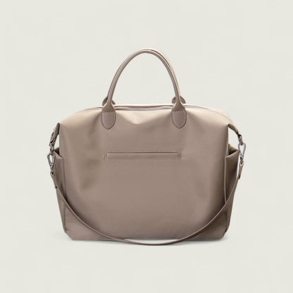 Beige handbag with a shoulder strap on a light beige background