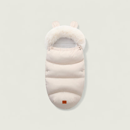 White baby sleeping bag with fur trim on a light gray background