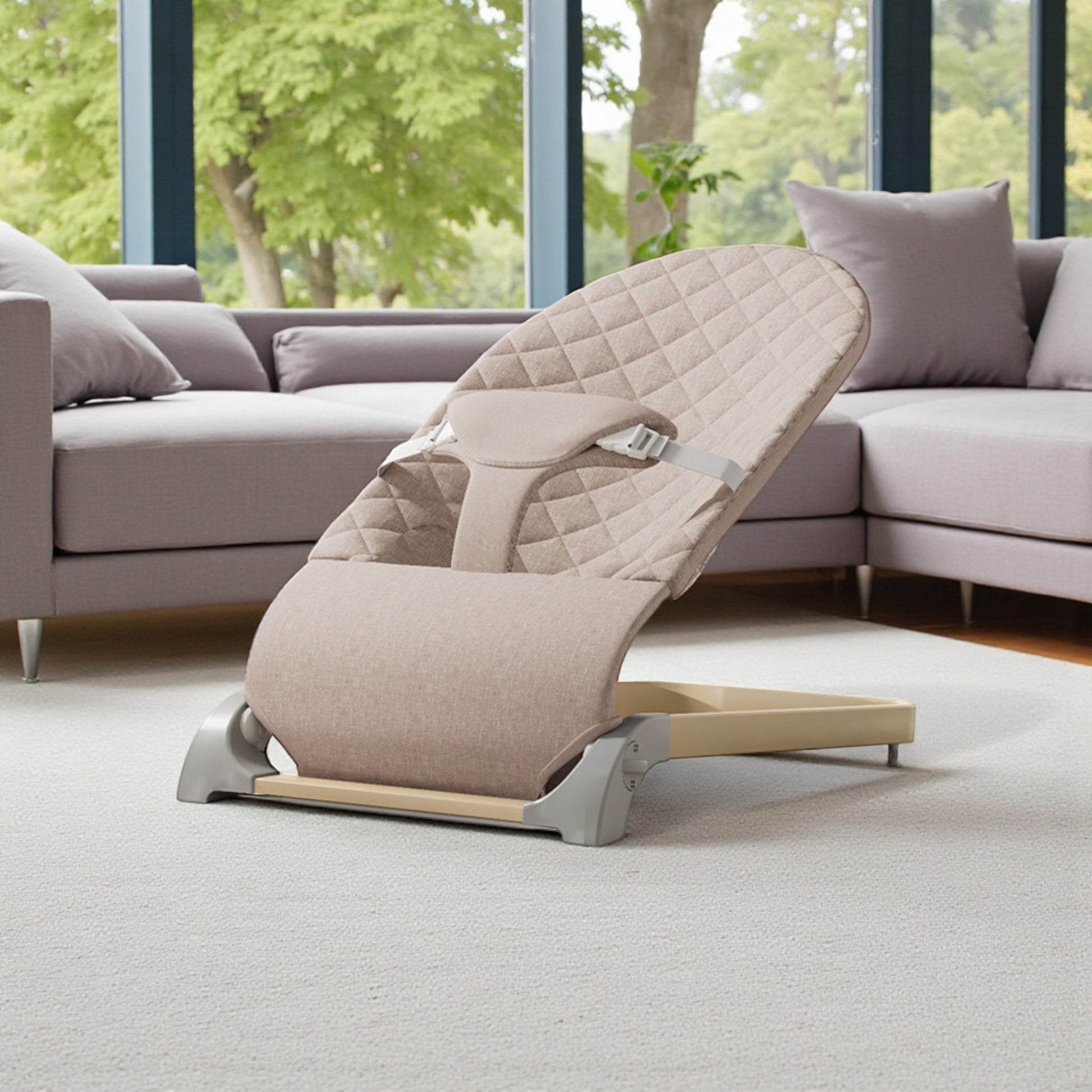 Beige recliner chair in a modern living room with large windows and a sofa.