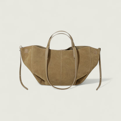 Brown suede handbag on a light beige background
