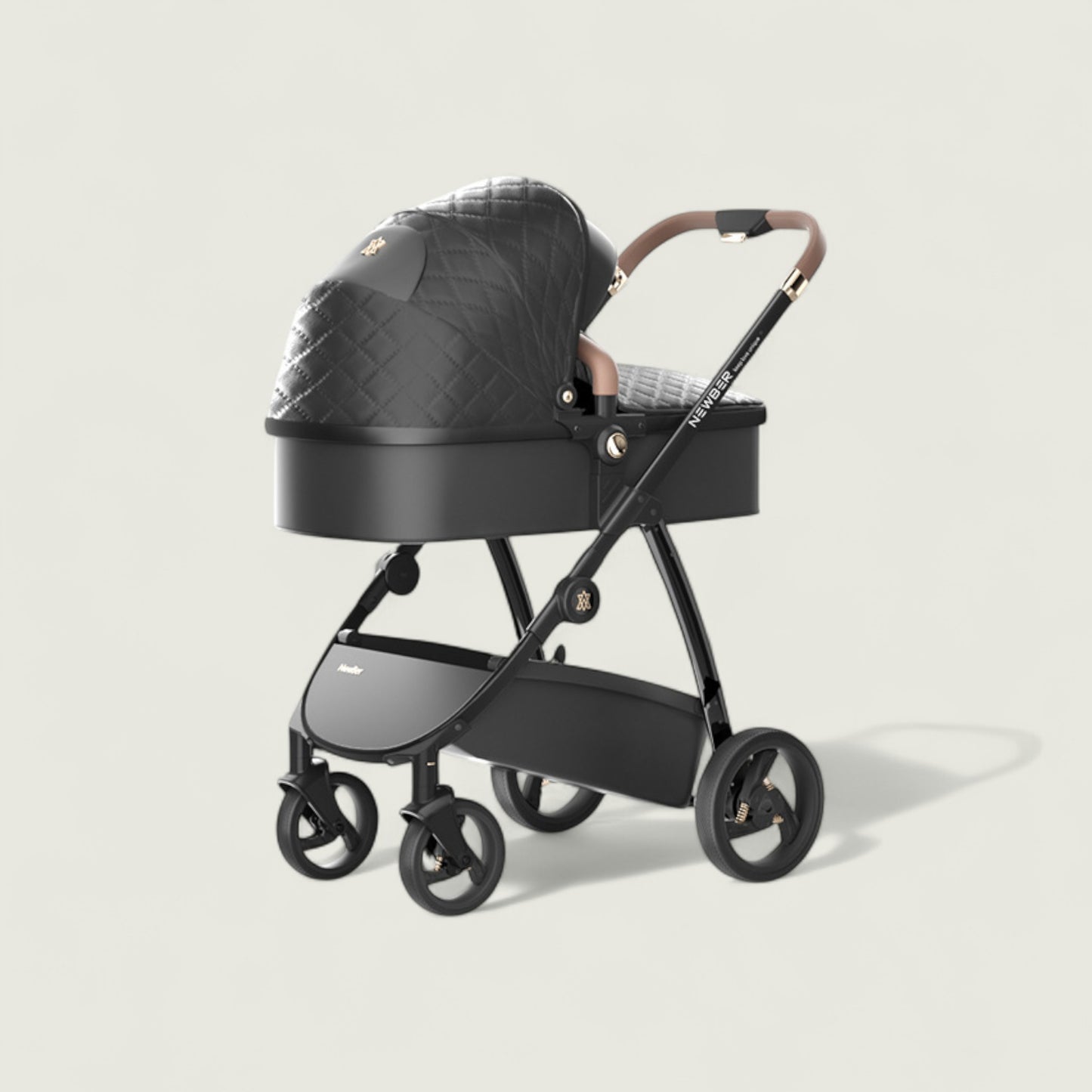 Black baby stroller with quilted black cover on a light beige background