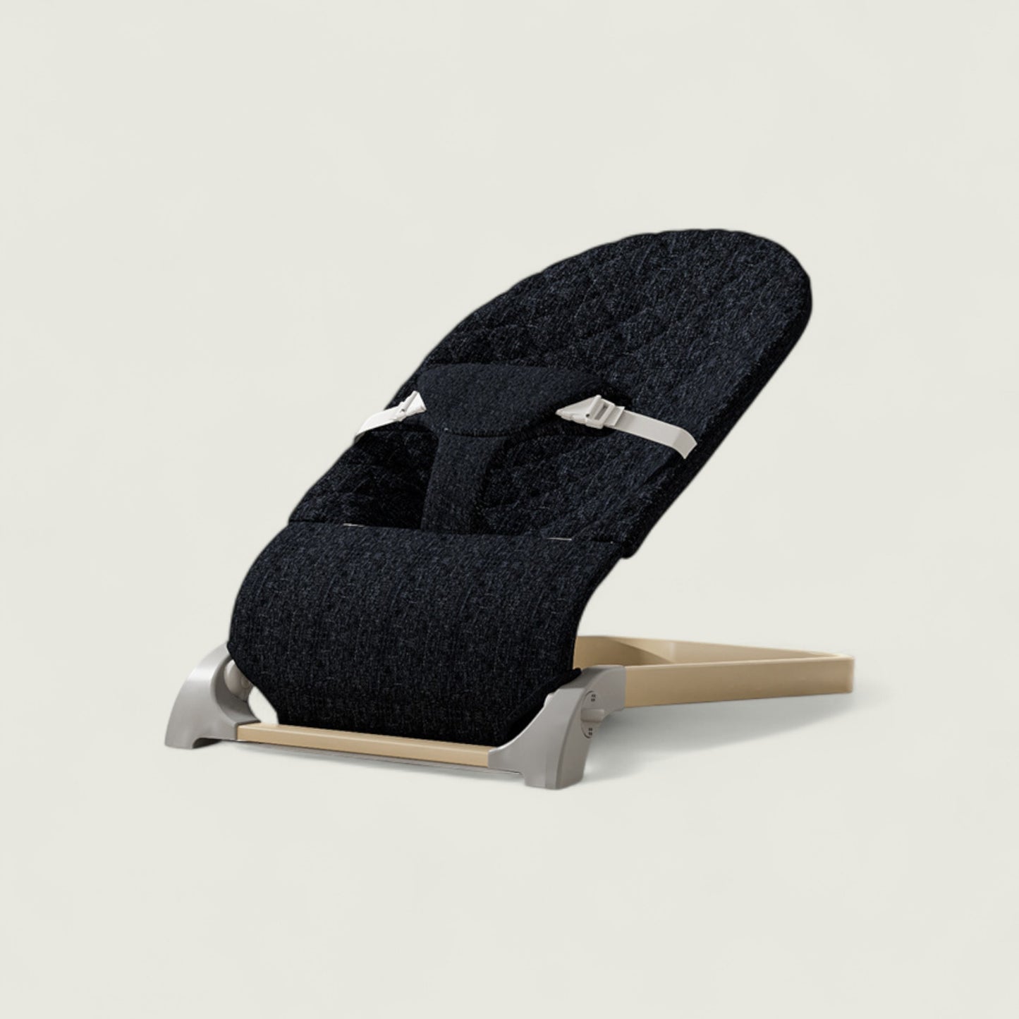 Black baby seat with beige base on a light gray background