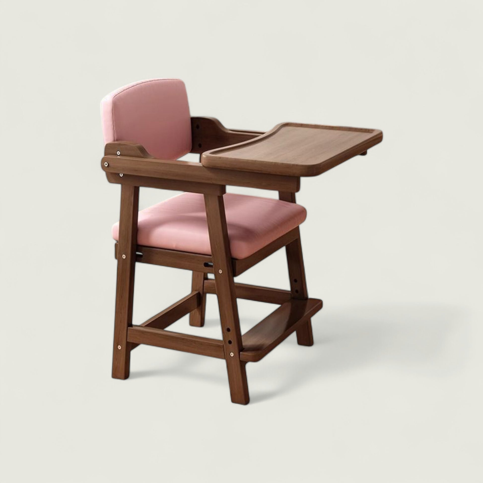 Wooden high chair with pink cushion on a light gray background