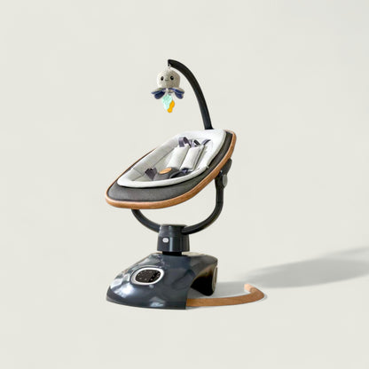 Baby swing with a toy on a light gray background