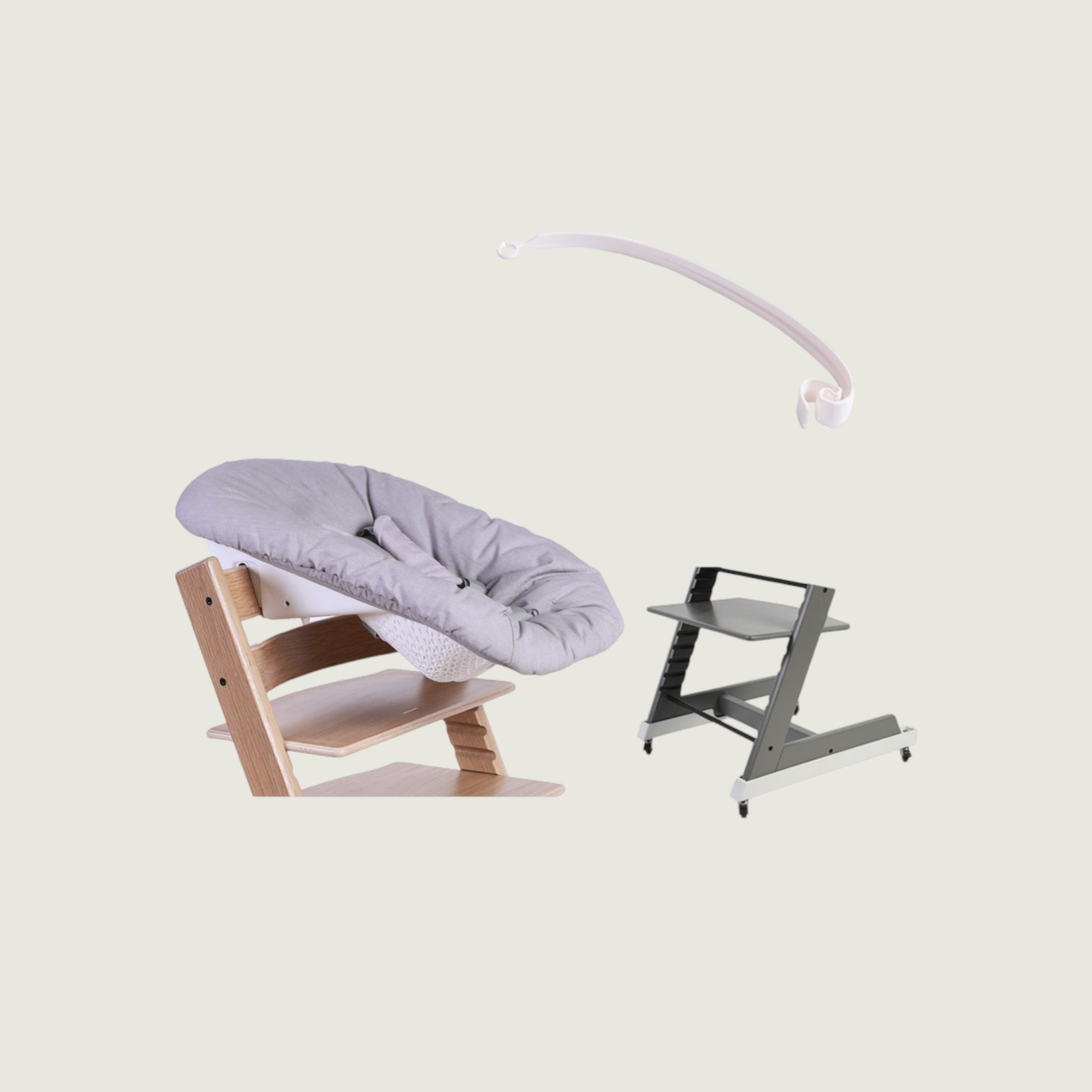 Baby bouncer and high chair on a light beige background