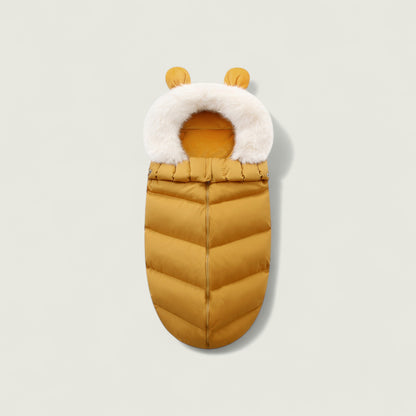 Yellow baby sleeping bag with white fur trim on a light gray background